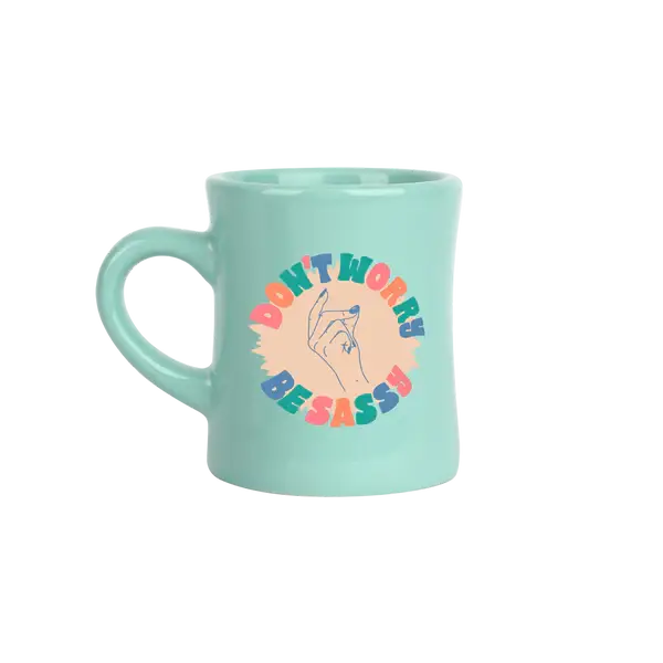Mint green mug with colorful text and snapping hand design says don't worry be sassy on a white background