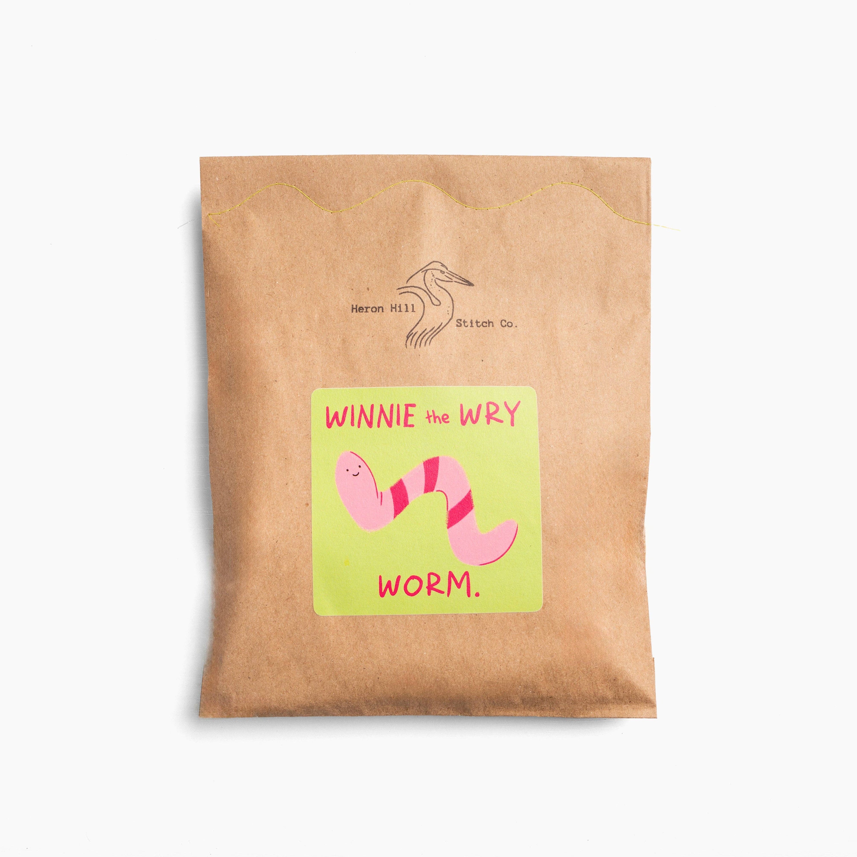 Kraft paper package with a colorful label featuring 'Winnie the Wry Worm' on a white background.