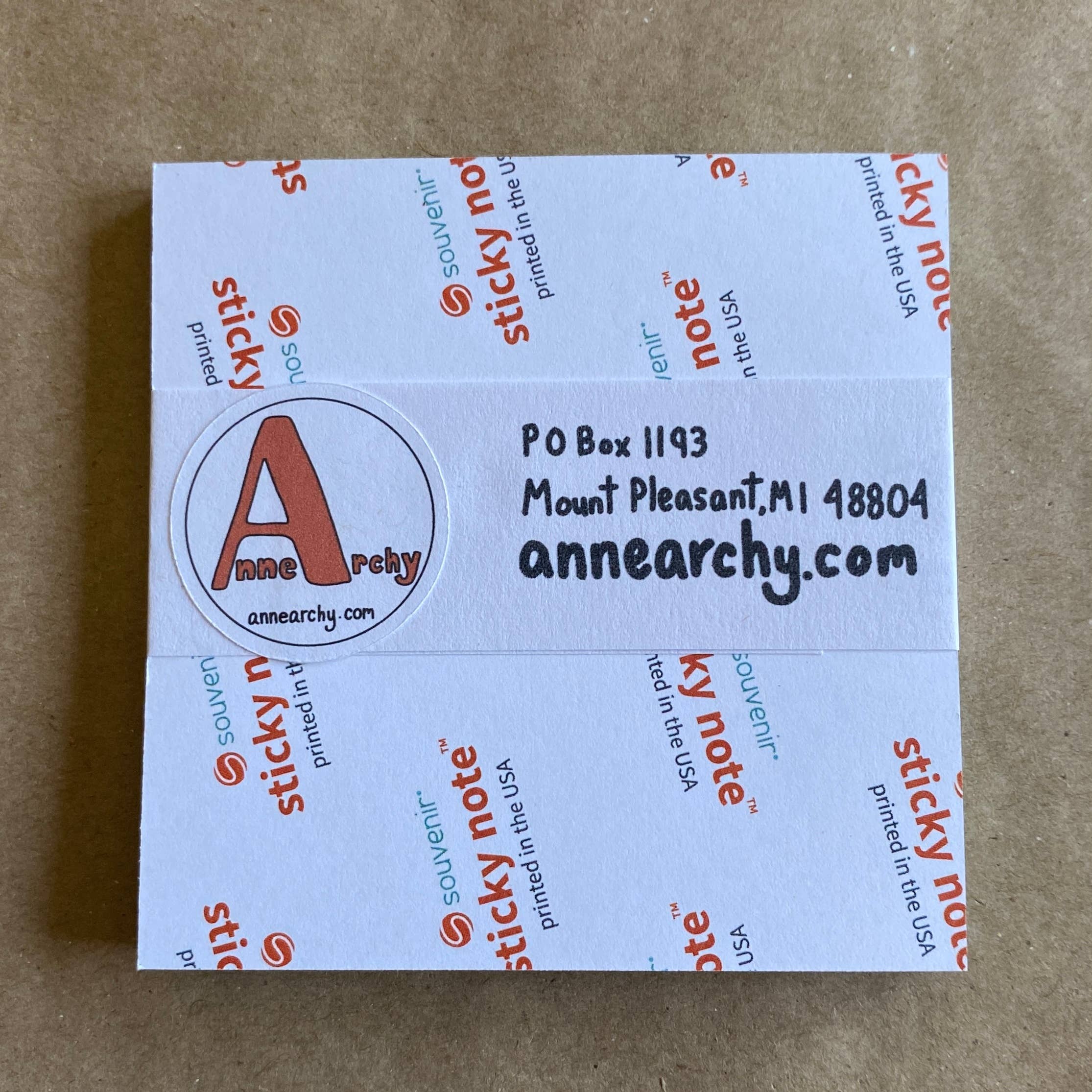 Packaging of sticky notes with Anne Archy branding on a brown background