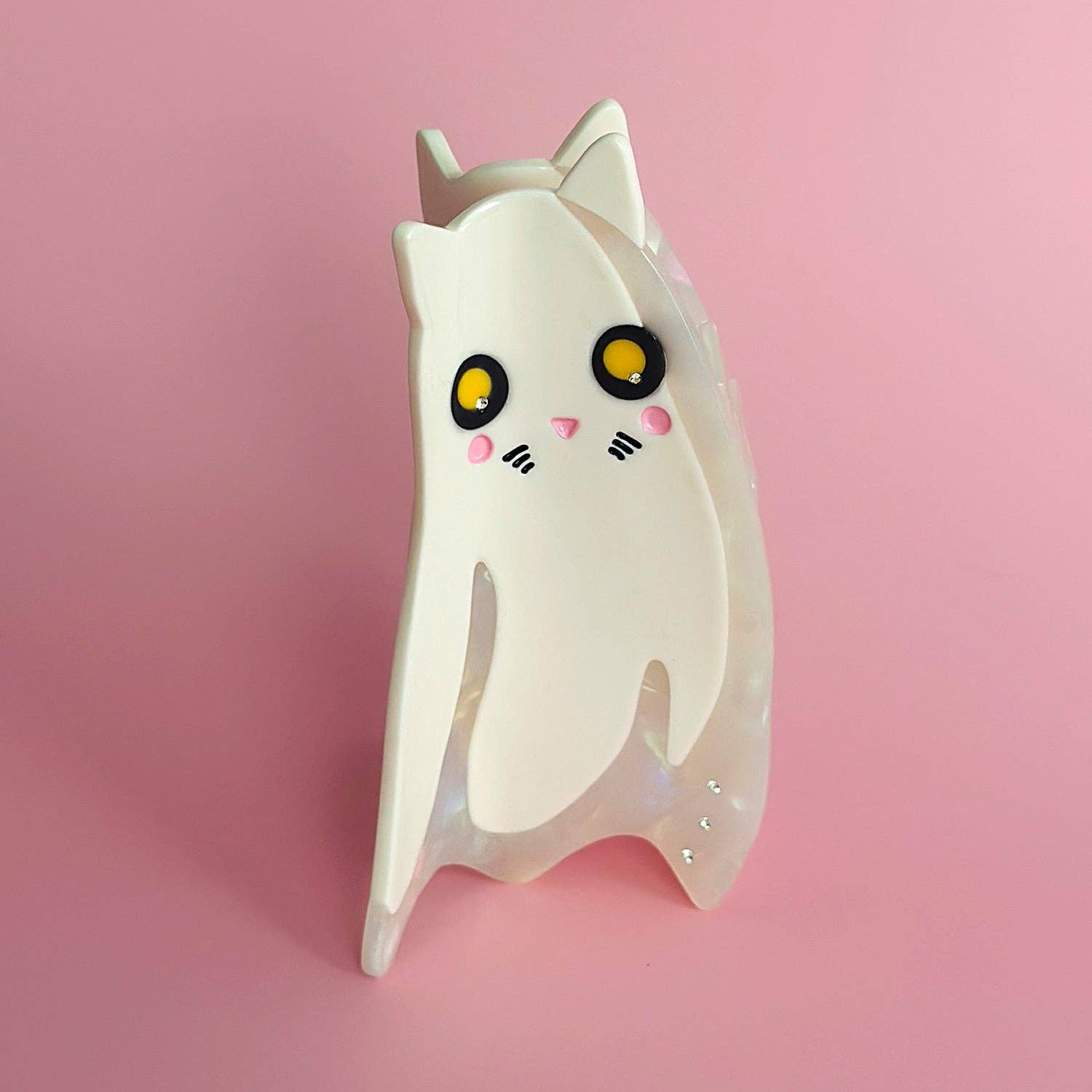 Cute white ghost cat-shaped night light on a pink background