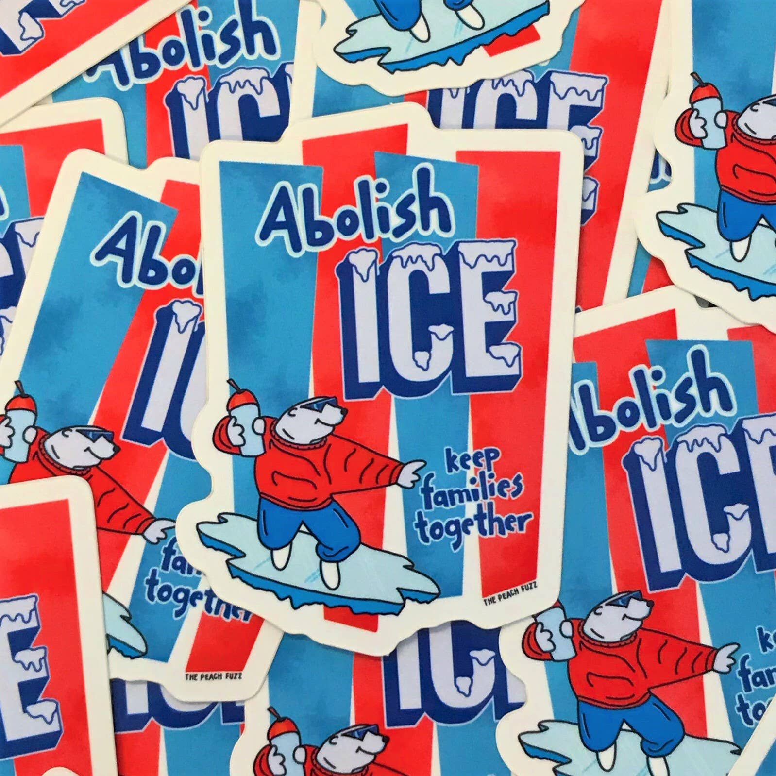 Stickers with 'Abolish ICE' text and a bear character on a red, white, and blue background.
