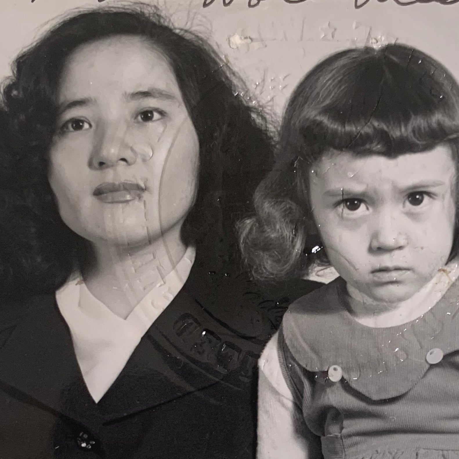 Black and white photo of a woman and a young girl with text overlay