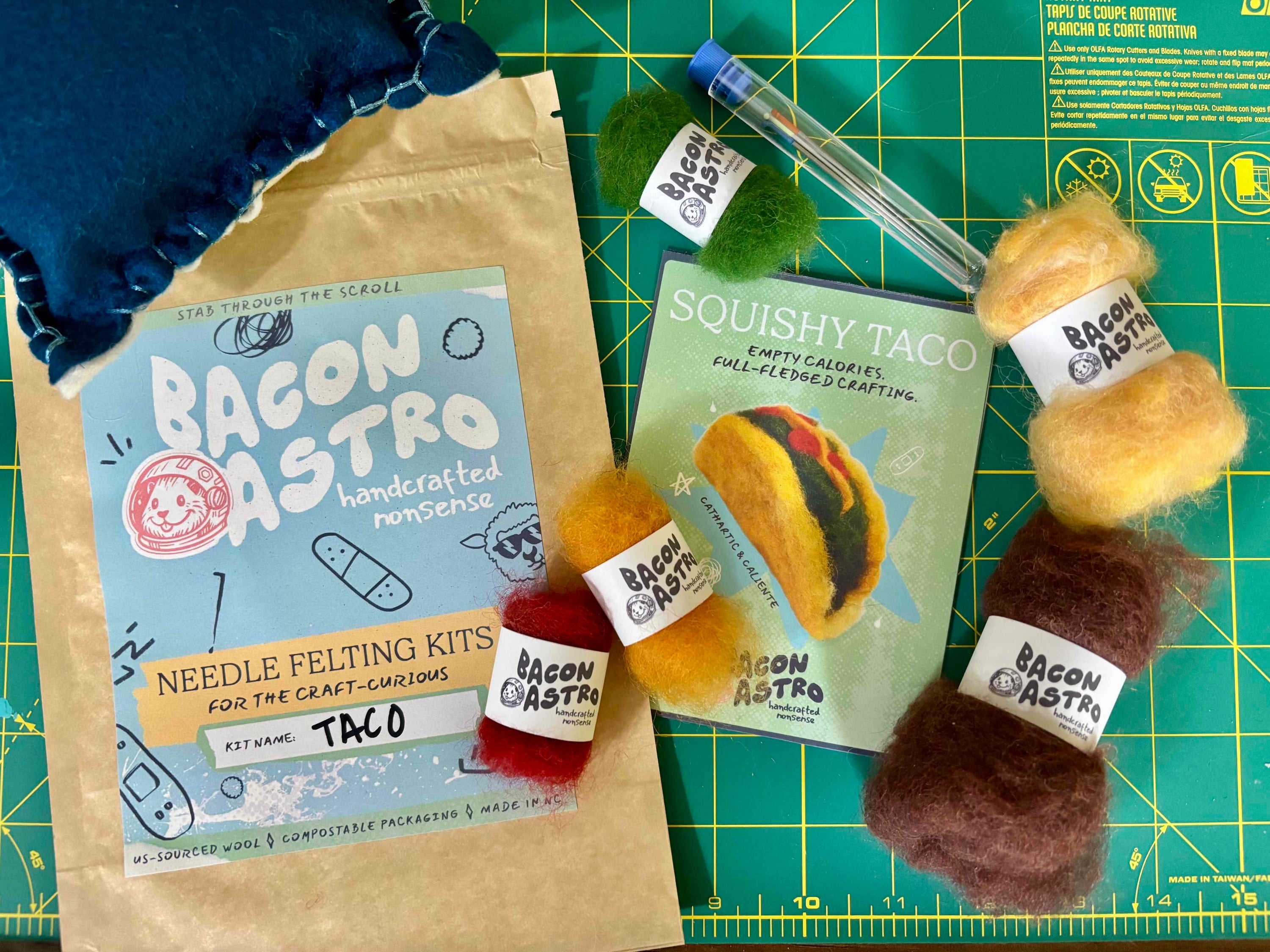 needle felting taco kit - wool needles and felting pad lay out next to compostable and sustainable packaging