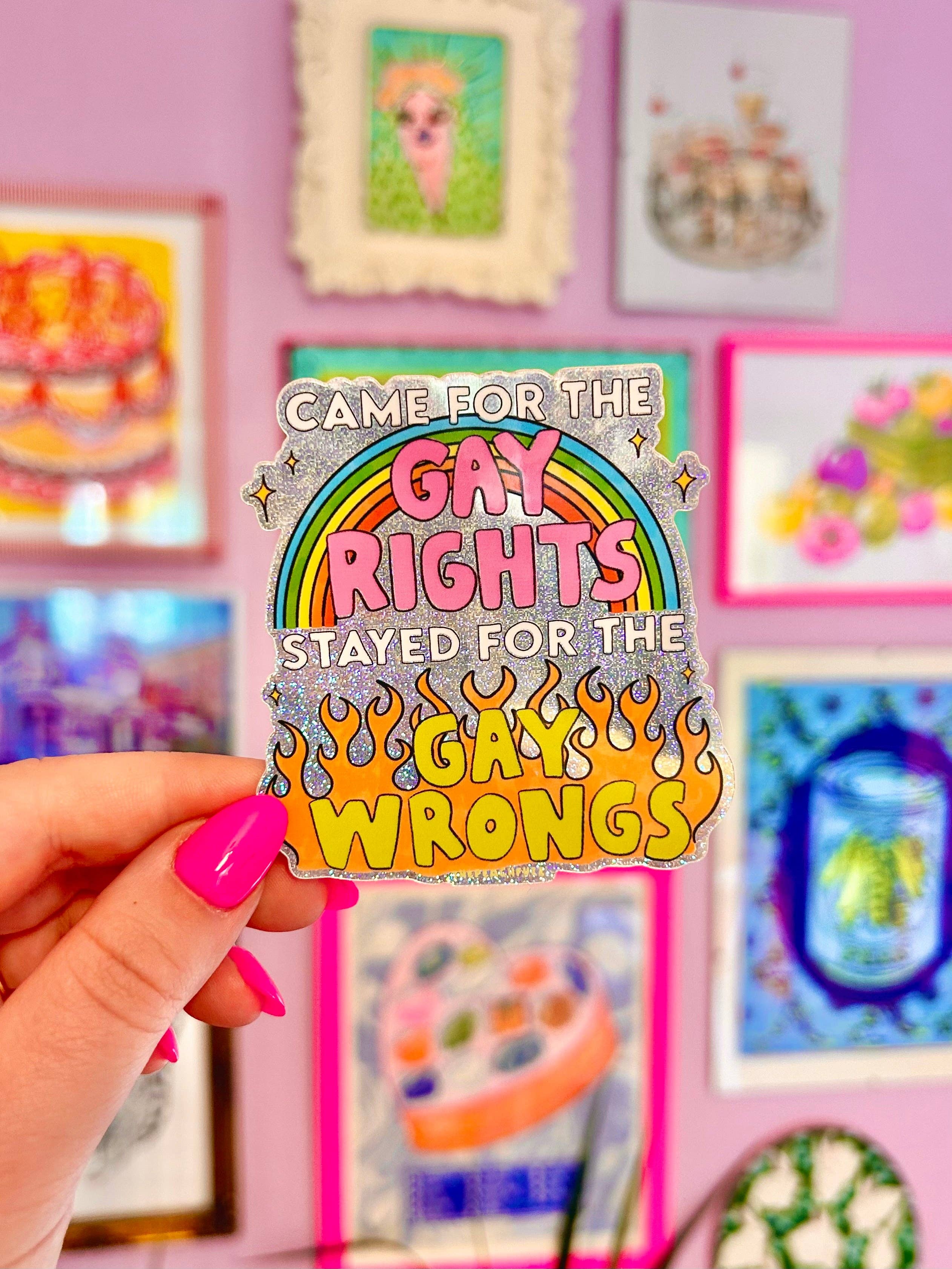 Pin with rainbow design and text held in front of a colorful background