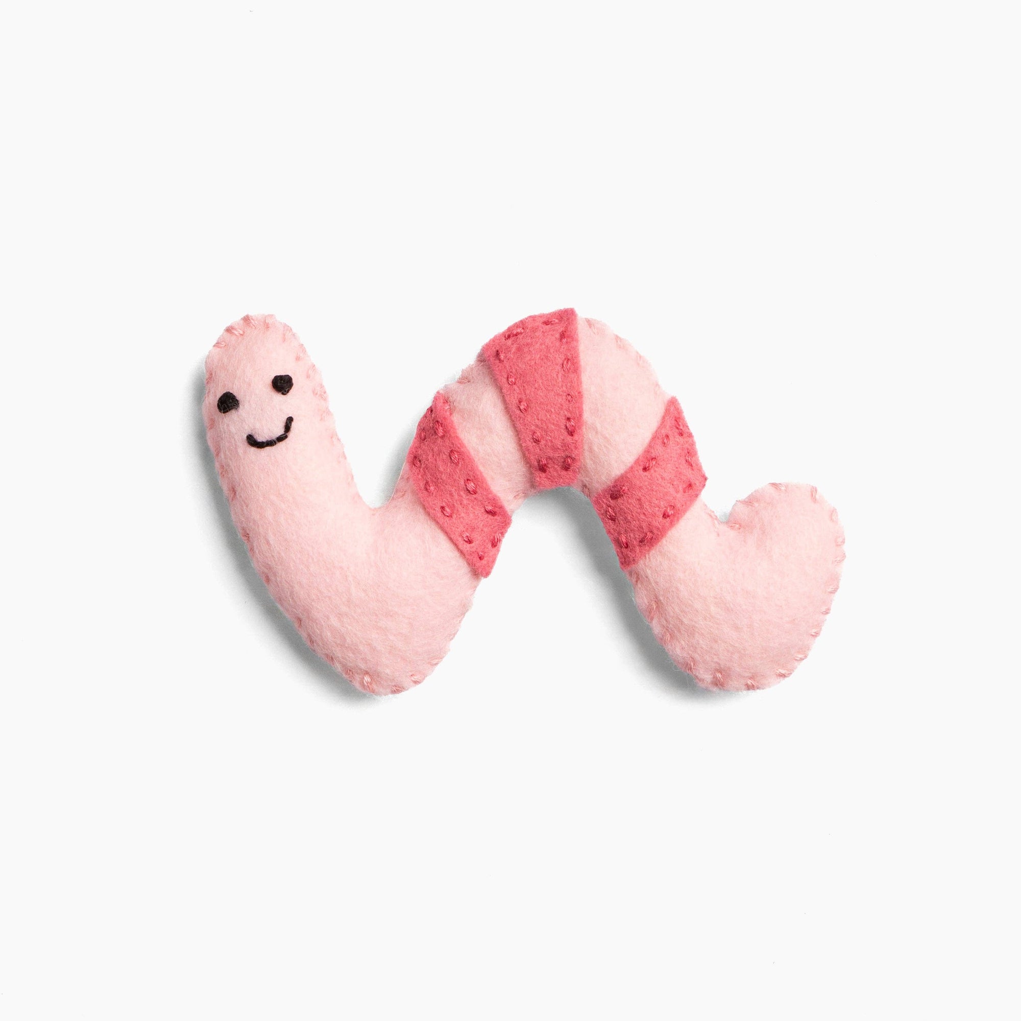 Pink plush toy shaped like a worm on a white background
