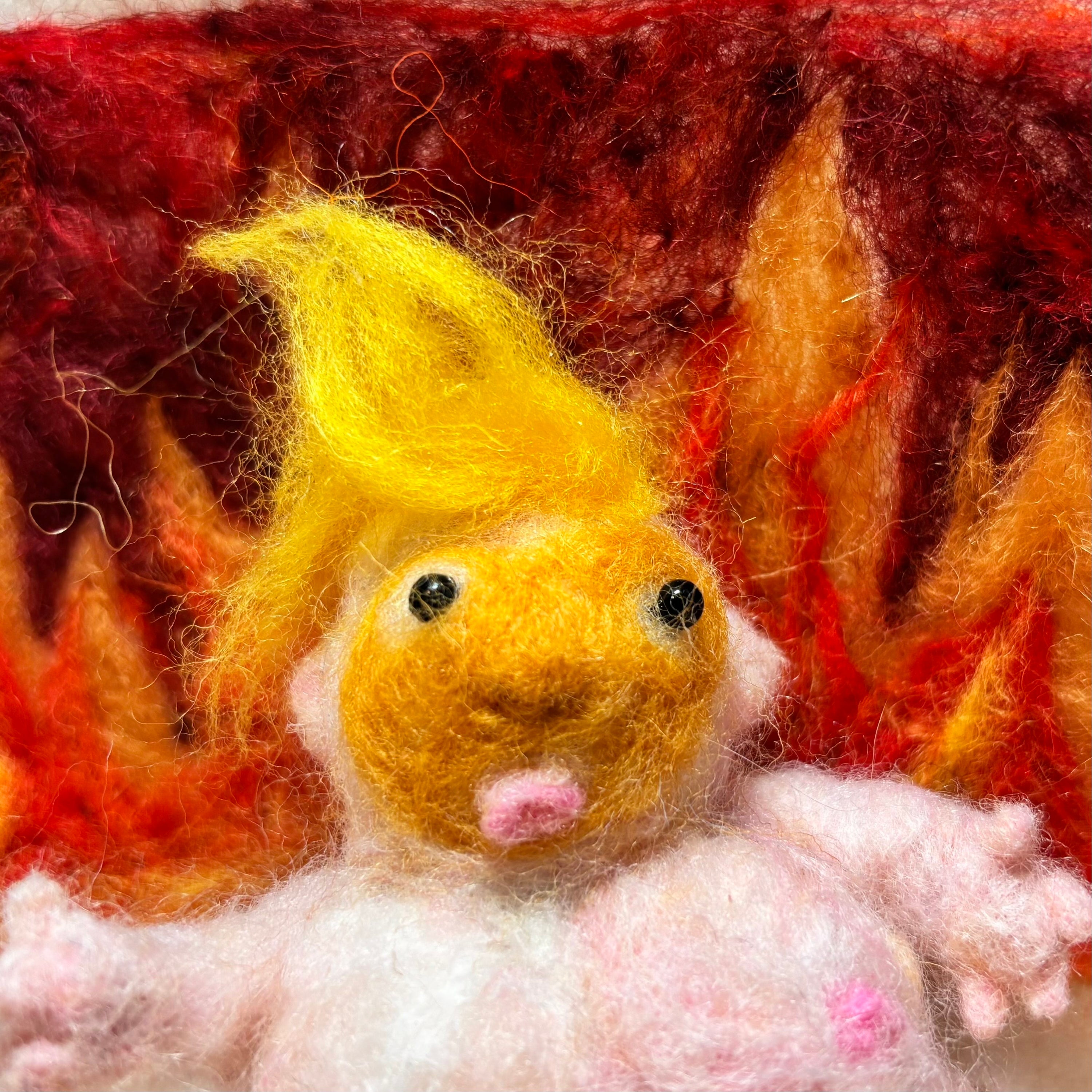 Needle Felted ugly president voo doo doll with a textured red and orange flame background