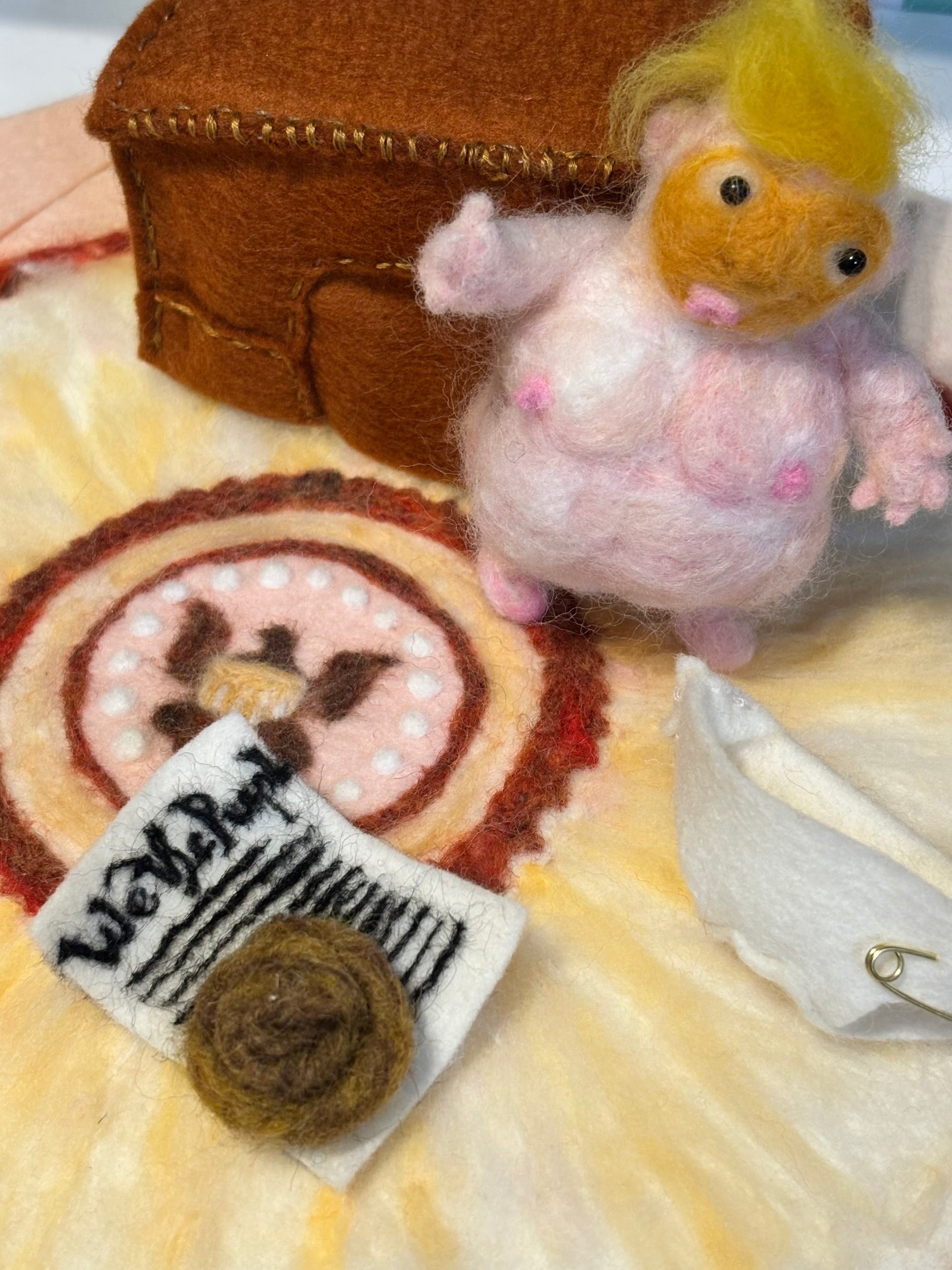 Small felted president creature with a brown pile of poop on the constitution and fabric background of the oval office