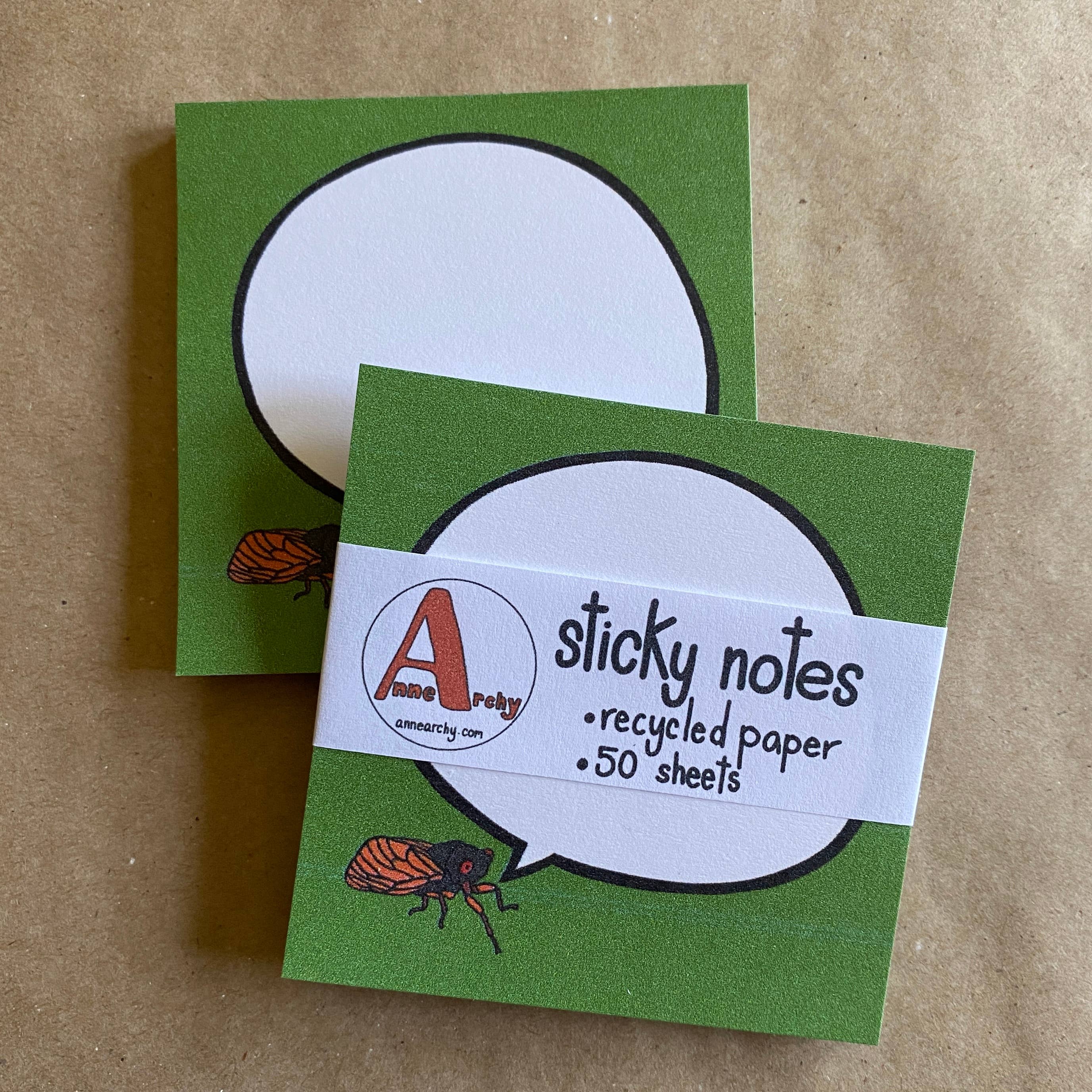 Green sticky notes of a cicada chirpy speech bubble with a label on a brown background