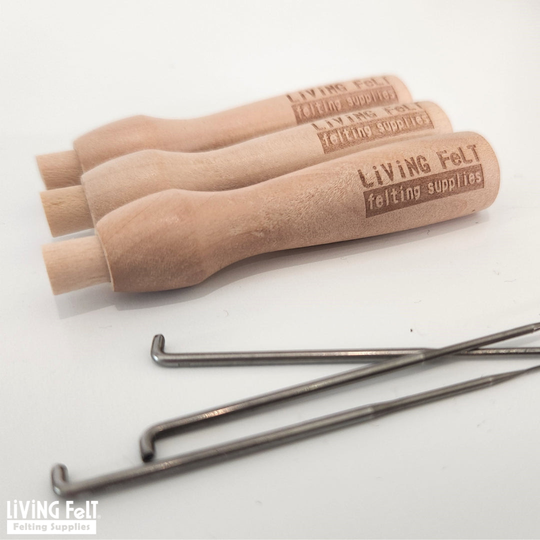 Three wooden needle felting needle holders from Living Felt felting supplies on a white background